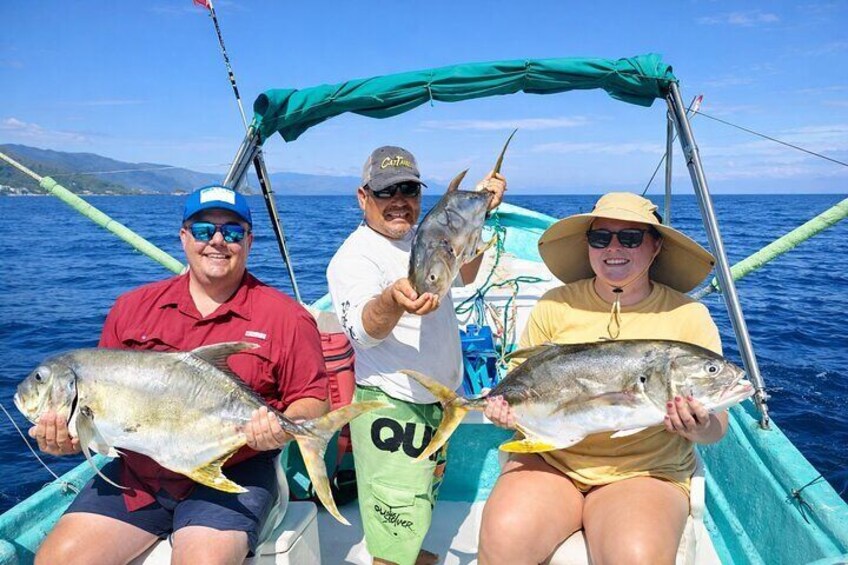 Three people on a boat holding fish. 1