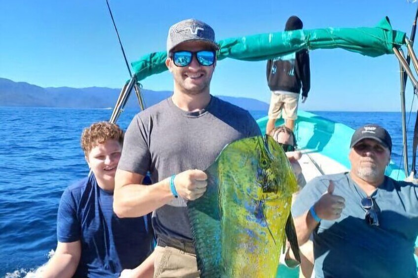 A boat with three people holding a fish. 2