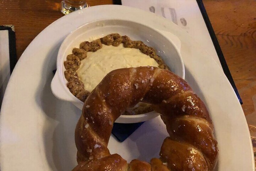 A plate with a sausage and a bowl of soup. 5