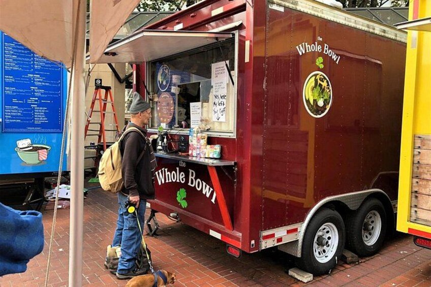 A red food truck with a sign reading 'The Whole Bowl.' 2