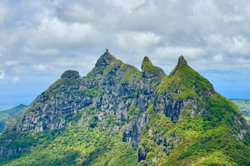 A mountainous landscape with prominent peaks and lush greenery. 5
