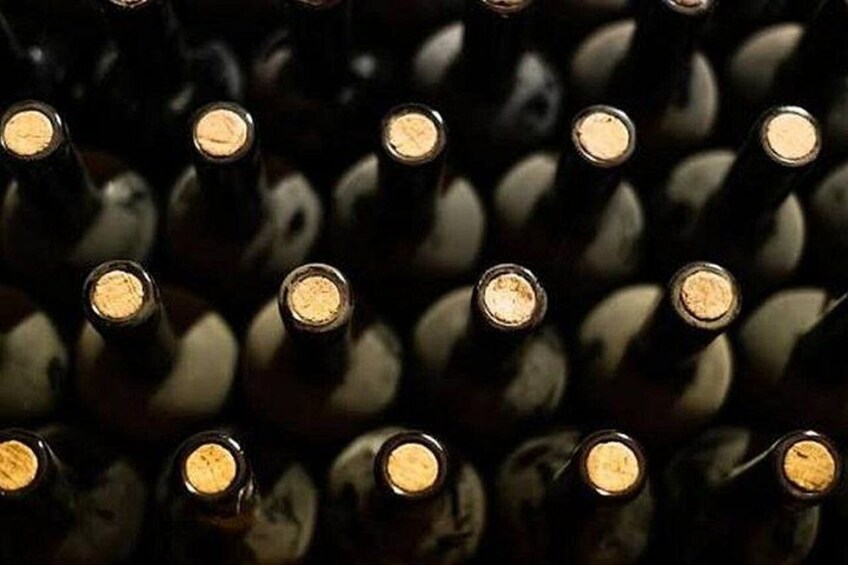 A collection of wine bottles with corks in the center. 4