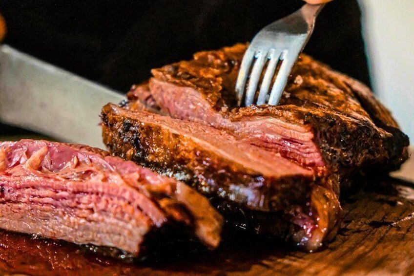 A steak being cut with a fork. 1