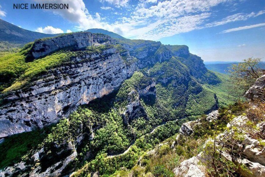 A mountainous landscape with cliffs and greenery. 3
