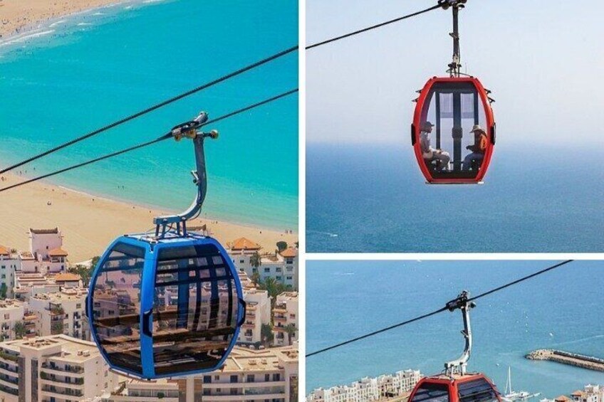 A cable car system with a blue gondola and a red gondola over a coastal cityscape. 4