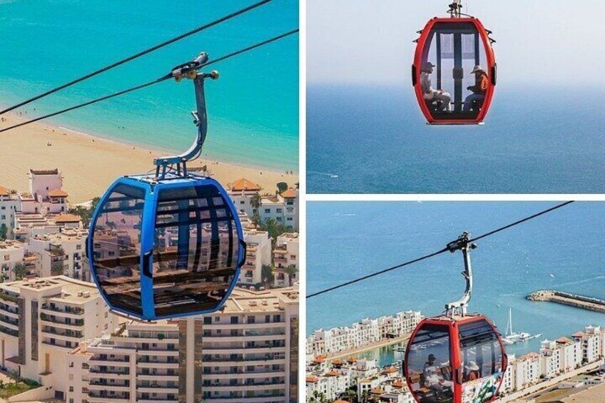 A cable car system with a blue gondola, a beach, and a coastal cityscape. 3