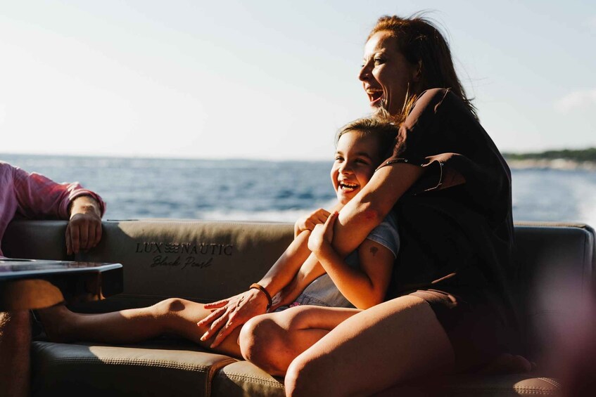 A person sitting on a couch with a view of the ocean. 1