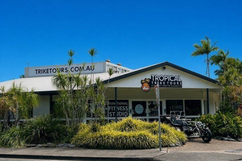 A building with signs for 'TRIKETOURS.COM.AU' and 'TROPICAL TRIKE TOURS.' 4