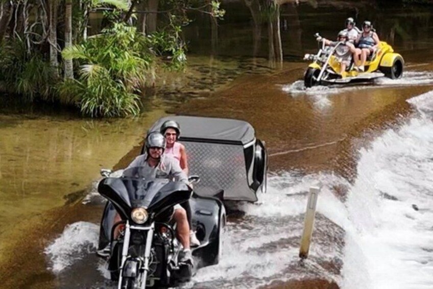 A watercraft navigating through a flooded area with vegetation on the banks. 3