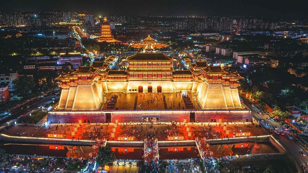 A brightly lit traditional Chinese building with a large courtyard and surrounding walls. 4