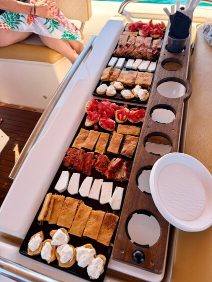 A tray with various food items, including meats, cheeses, and bread. 5