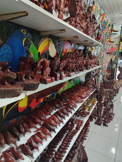Shelves of wooden carvings, including animal figures and decorative items. 2