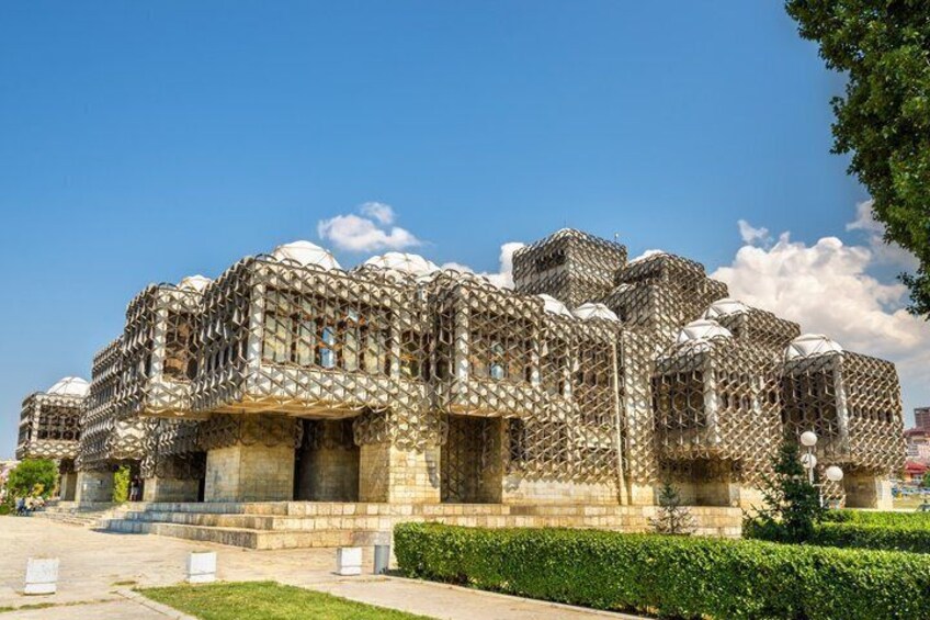 A building with intricate latticework and domed structures. 1