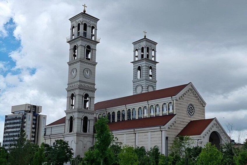 A church with two bell towers and a clock. 2
