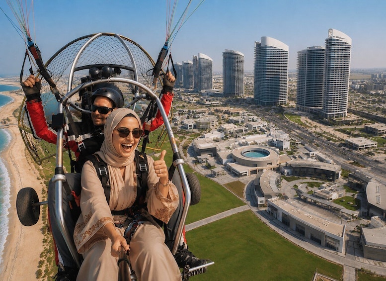 A person on a cable car with a cityscape in the background. 4