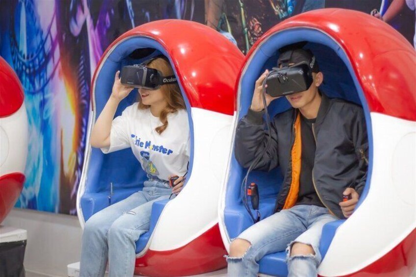 Two people seated in red and white booths using VR headsets. 4