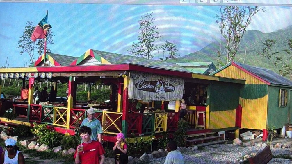 A colorful outdoor restaurant with a sign reading 'Chicken Party.' 5