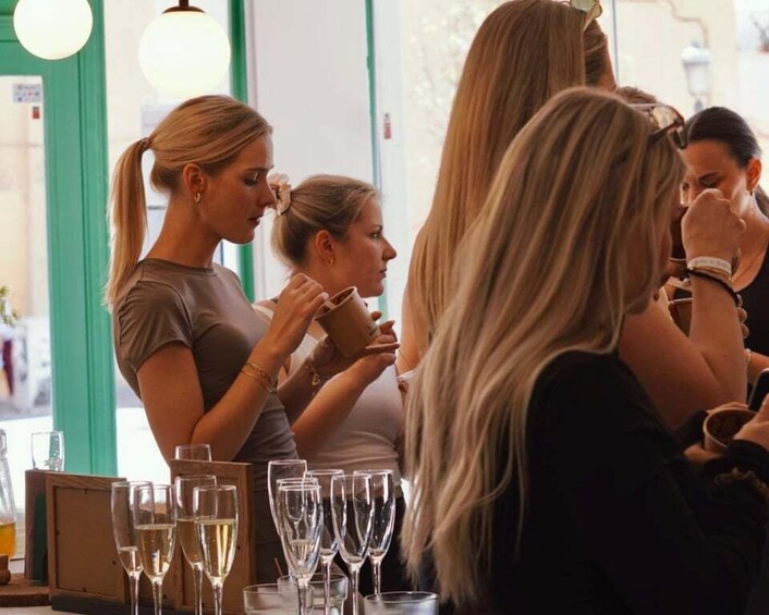 A group of people at a bar with glasses of wine. 1