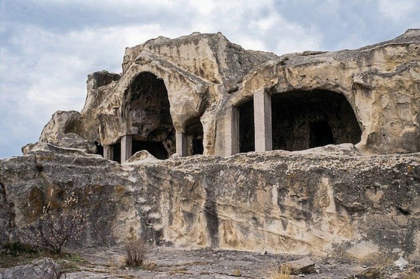 Ancient rock-cut tombs with multiple archways. 2