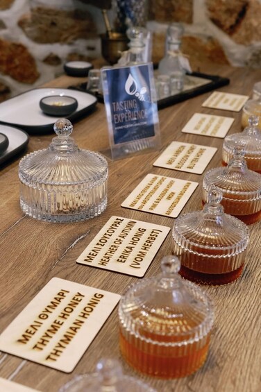 A tasting table with various honey jars and labels. 4