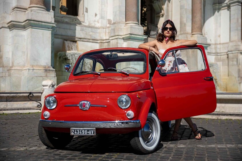 A red vintage car parked on a cobblestone street with classical architecture in the background. 4