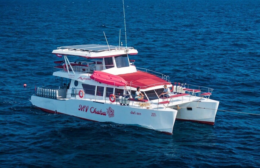 A MV Chaba catamaran with passengers on deck, sailing on blue water. 1