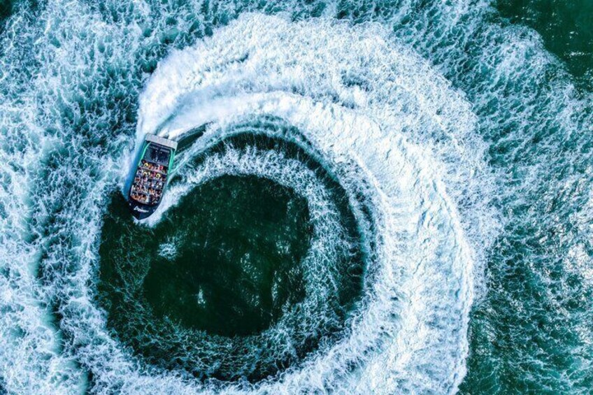 A boat creating a circular wake in the water. 3