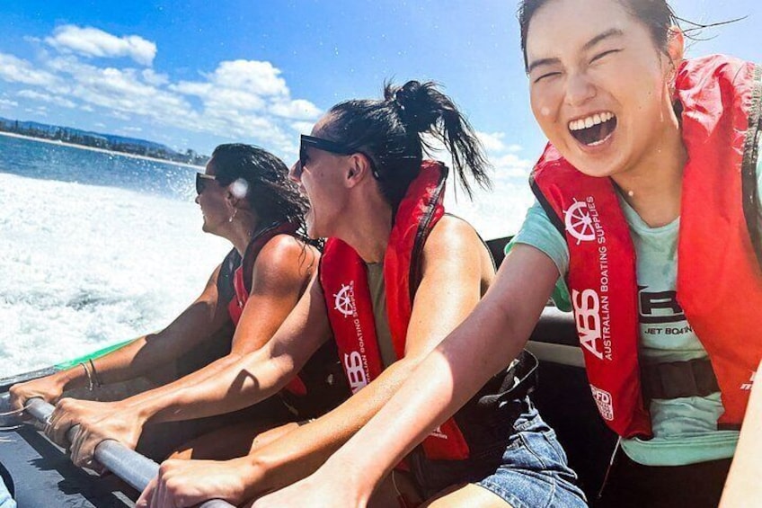 People on a boat wearing life jackets and a logo on their vests. 4
