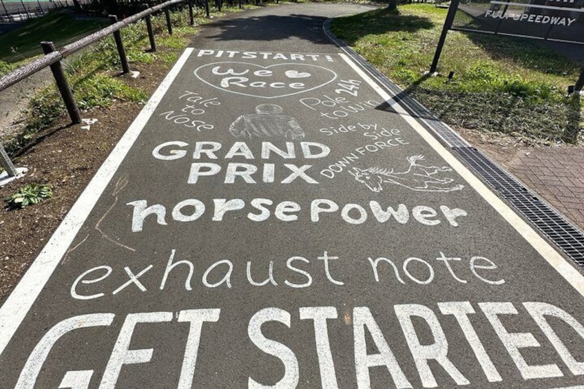 A race track with a sign that reads 'PITSTART Race' and 'Grand Prix' with a horse and rider illustration. 4