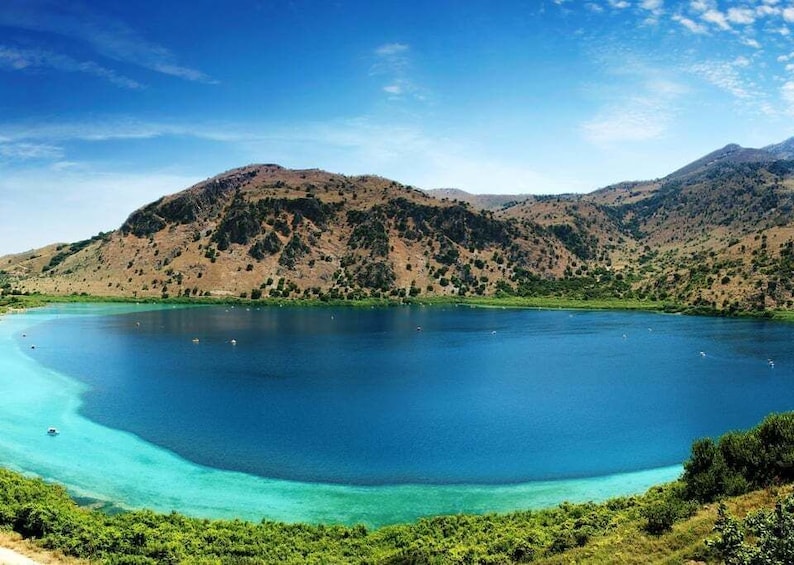 A large lake surrounded by hills and clear blue water. 1
