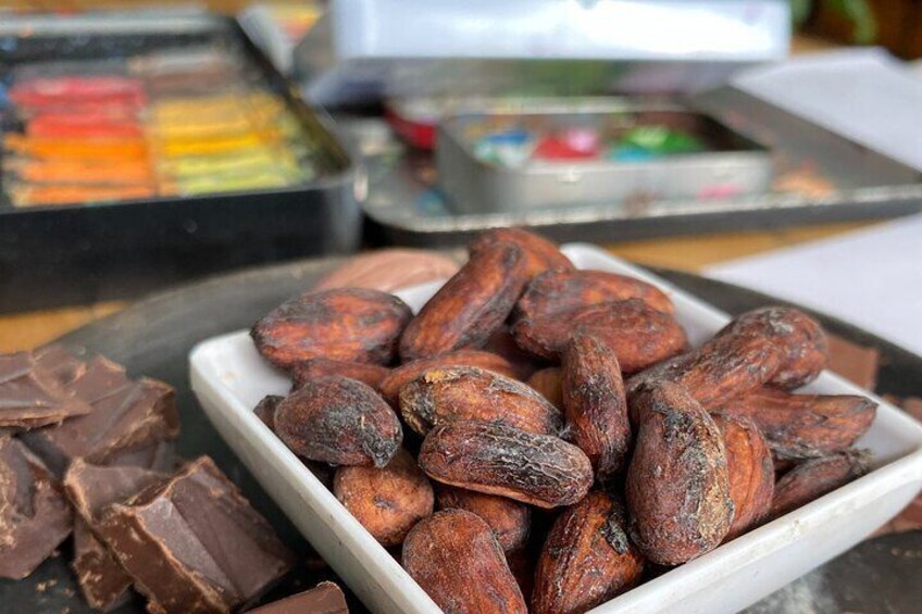 A tray of roasted cocoa beans and chocolate pieces. 1