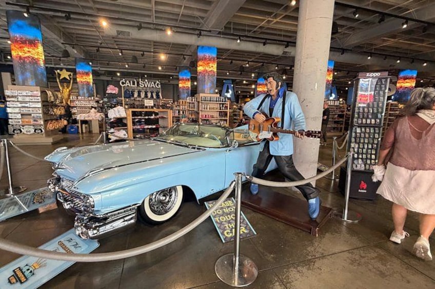 A vintage car exhibit with a man playing a guitar. 2