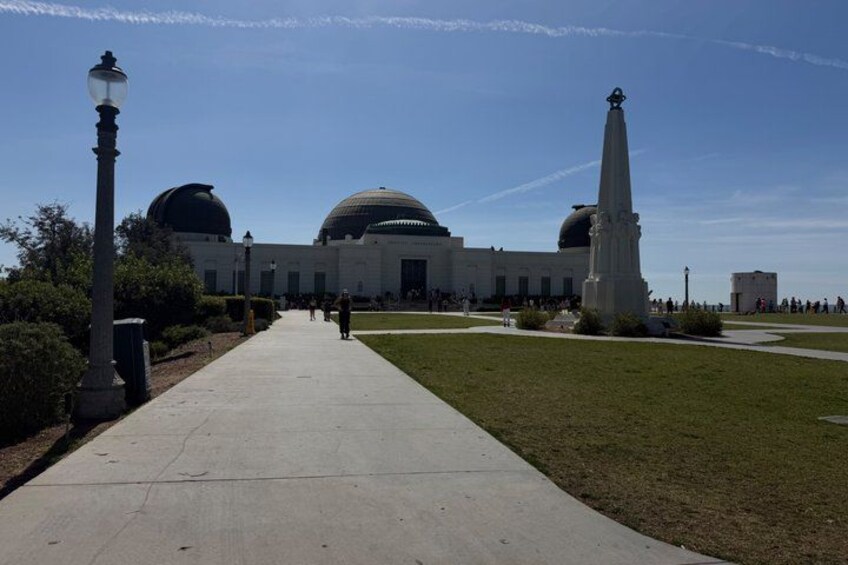 A building with domes, a statue, and a clear sky. 2