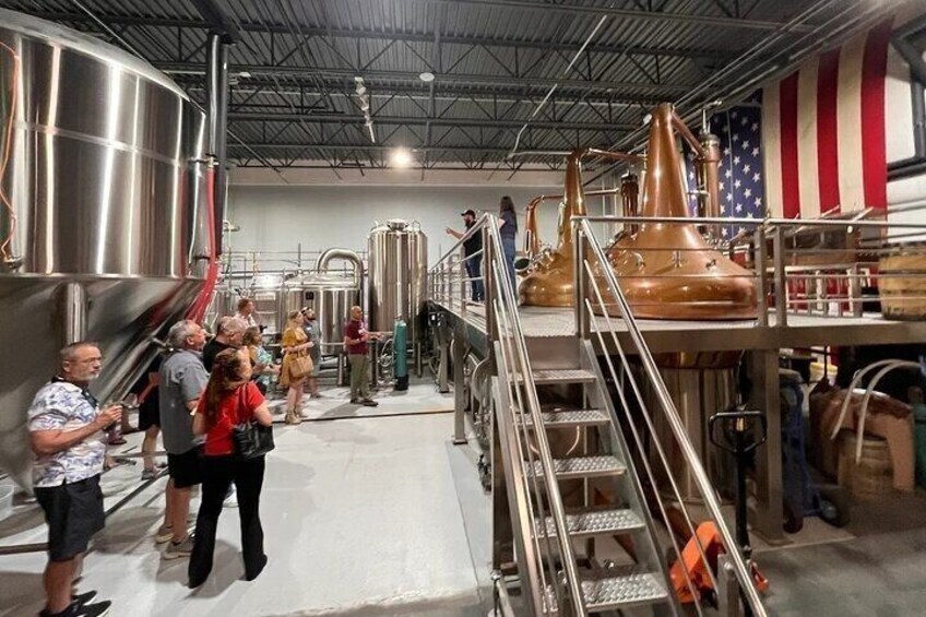 A brewery tour with stainless steel tanks and copper fermenters. 4