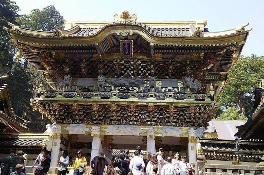 A traditional multi-tiered temple with ornate decorations and statues. 1
