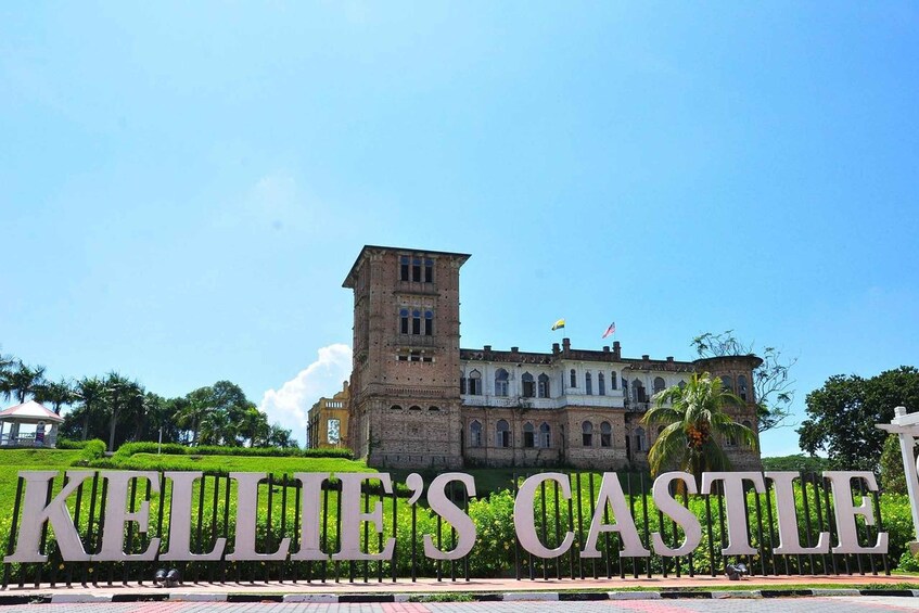 Kellie's Castle with a prominent sign and a tower. 4