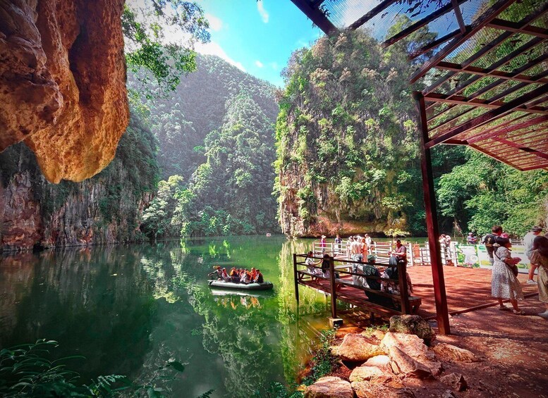 A river with a boat, a wooden bridge, and a rocky cliff. 2