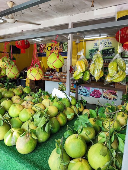 A fruit market with large green melons on display. 3