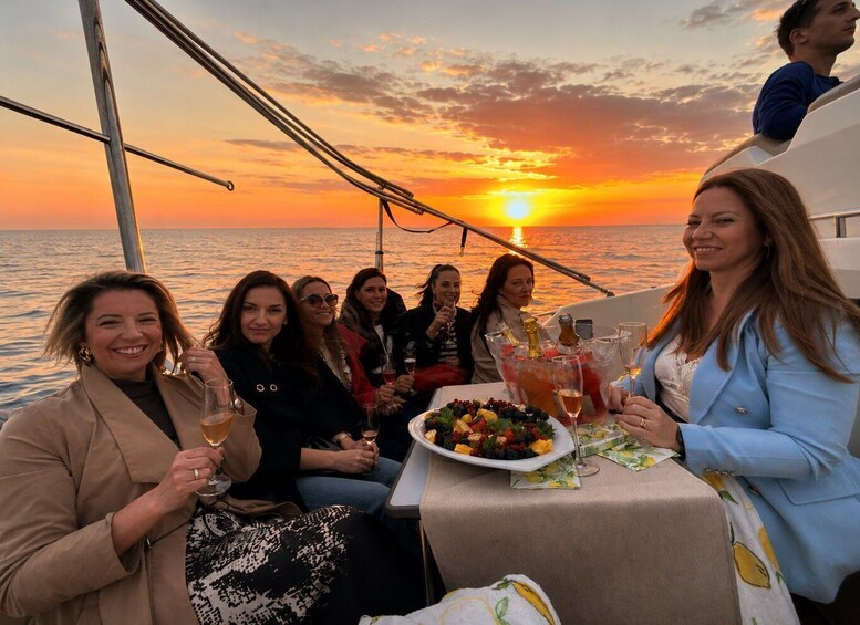 A group of people on a boat at sunset. 2