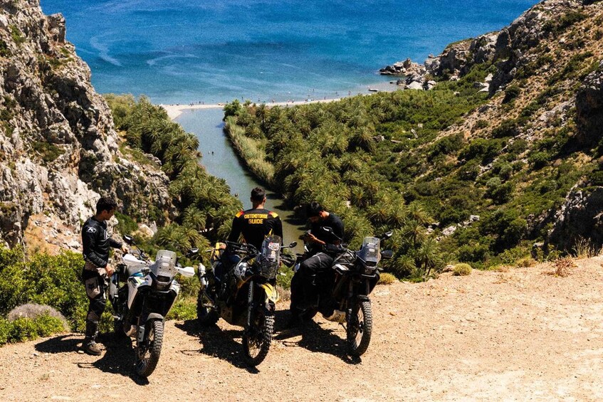 A group of motorcyclists on a dirt road with a coastal view. 3