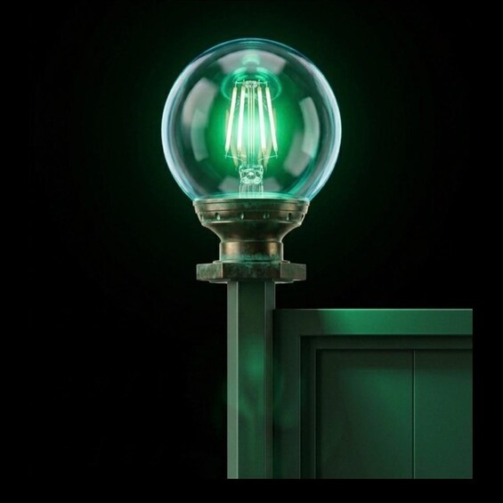 A green glass bulb with a metal base, mounted on a pole. 3