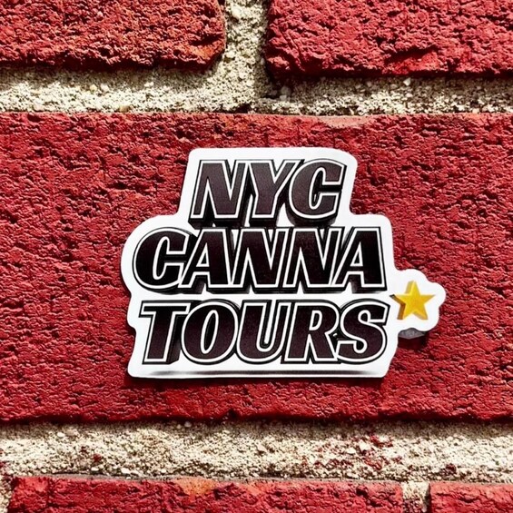 A sticker on a brick wall with the text 'NYC CANNA TOURS' and a star symbol. 1