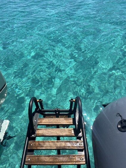 A wooden ladder leading into clear turquoise water. 5