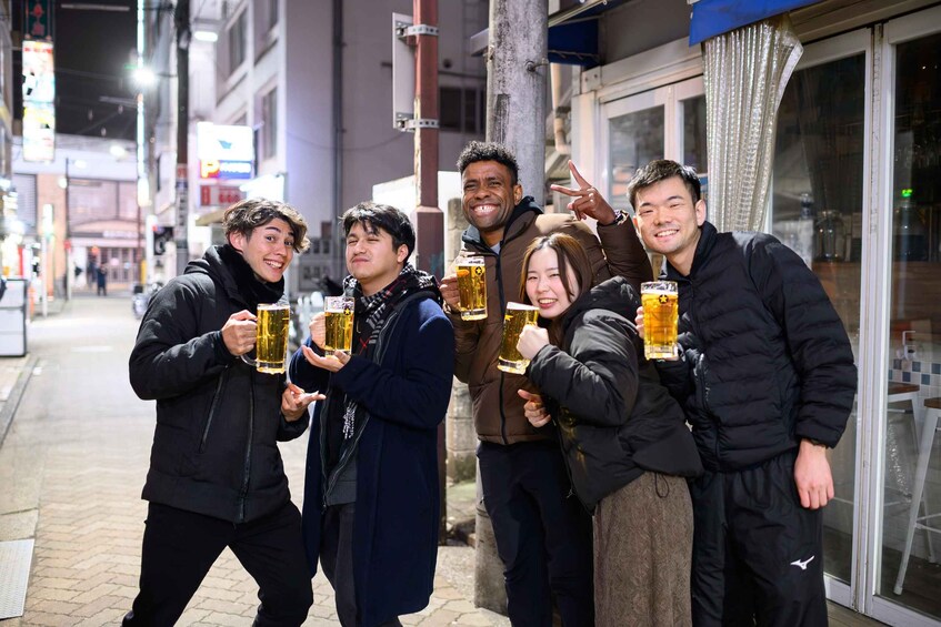A group of people holding beer mugs on a city street at night. 5