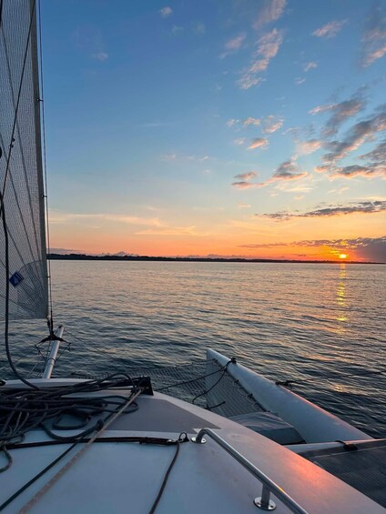 A sailboat at sunset with the sun reflecting on the water. 3