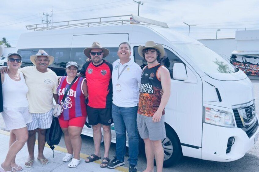 A group of people standing in front of a white truck. 2