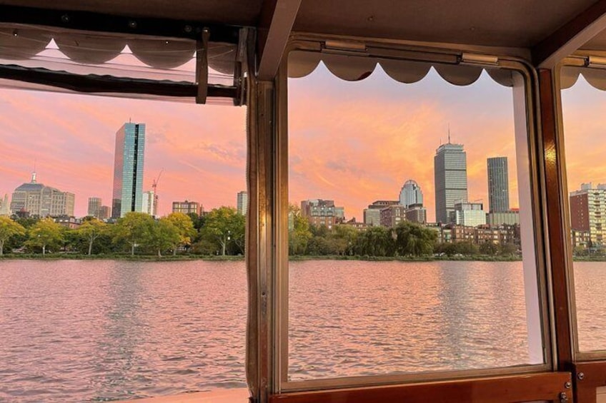 A river with a city skyline in the background during sunset. 3