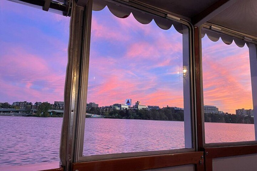 A sunset over a body of water with buildings in the background. 2