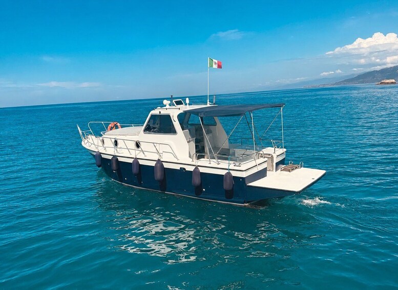A boat with a flag on a calm sea. 1