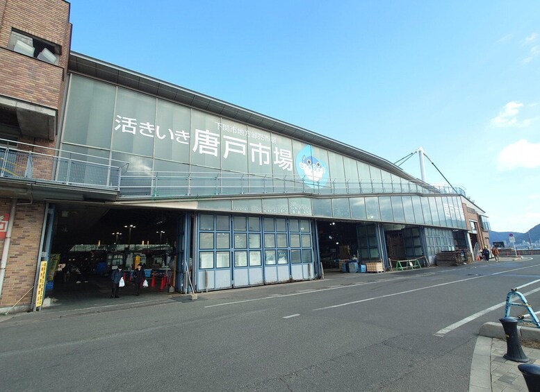 A commercial building with large glass windows and a sign in a foreign language. 2